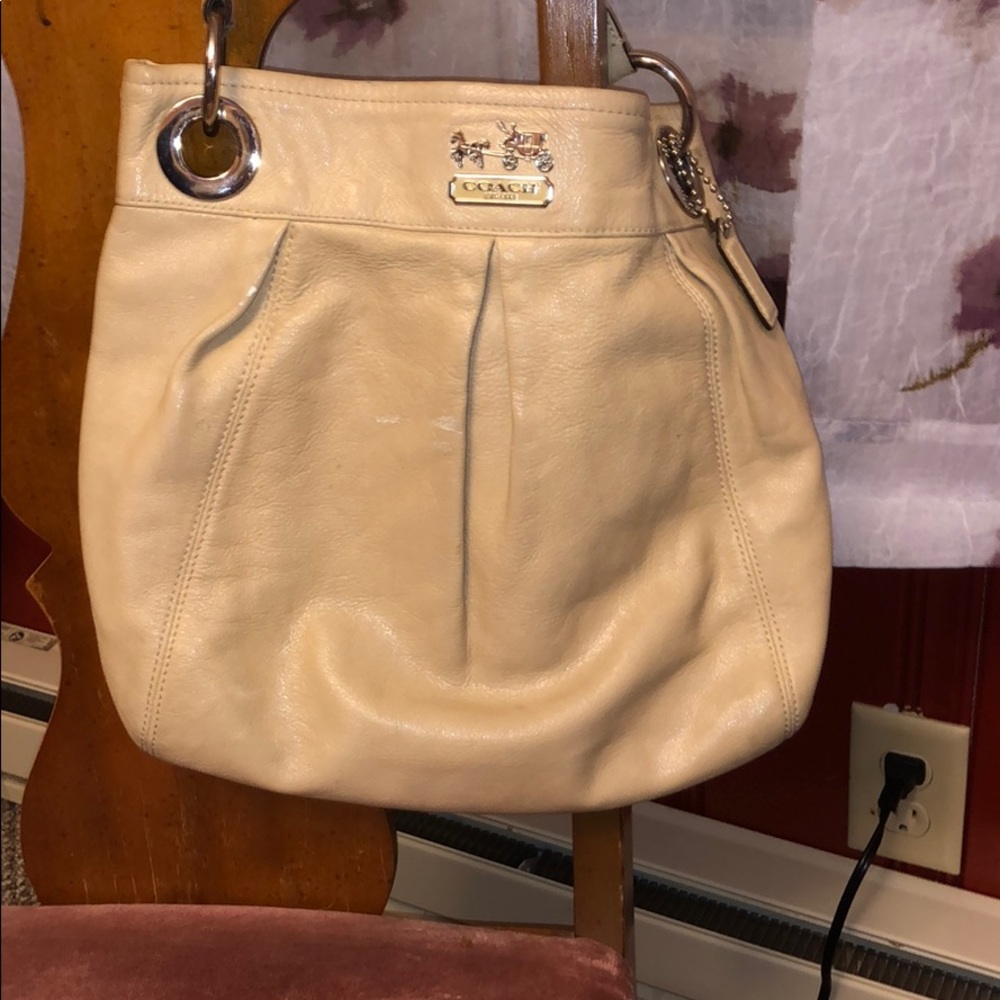 Tan leather coach hobo bag.  Clean, smooth, yes.